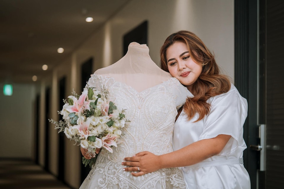 Medium shot of a bride showcasing her new custom design elegant gown